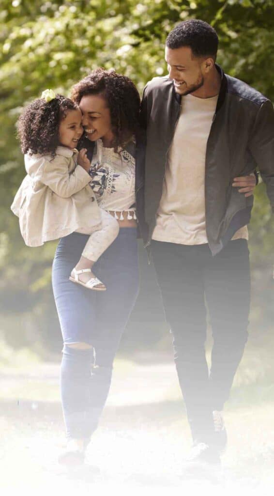 A family of child, mom and dad walking outside