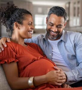 Man looks at pregnant wife's belly