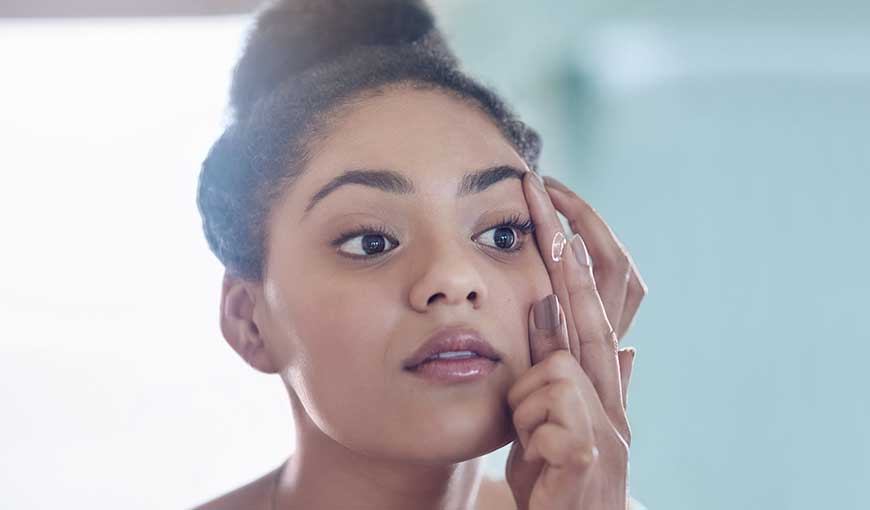 Woman putting in contact lenses